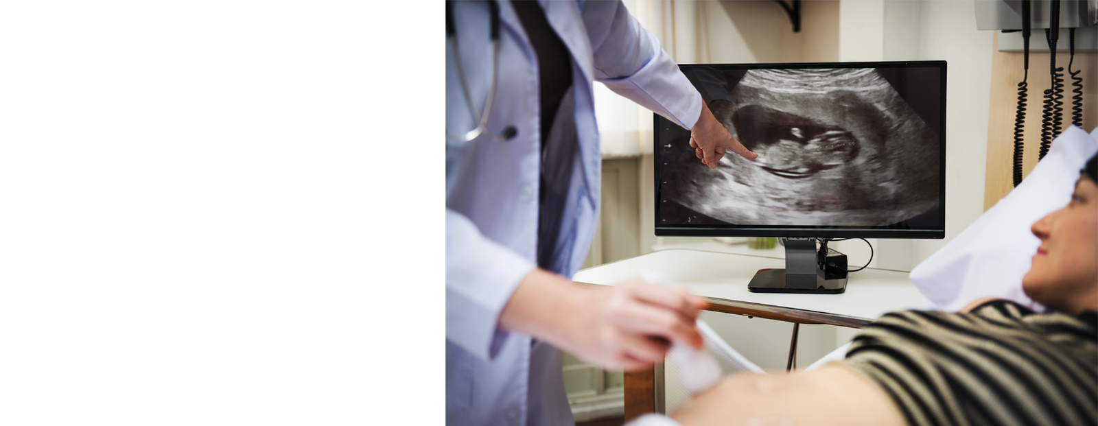 Happy couple looking at baby scan images